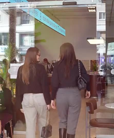 Customers walking into Fi Coffee, seen from behind